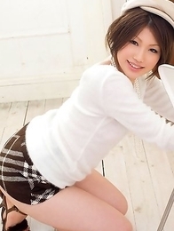 Risa Aika with sexy smile has naughty behind in short skirt