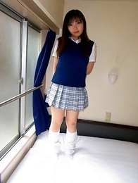 Haruka Ohsawa posing in her schoolgirl uniform and hiking up her top to show her big boobs