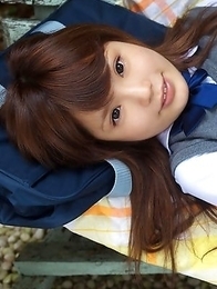 Manami Sato in short uniform skirt spends time in the park